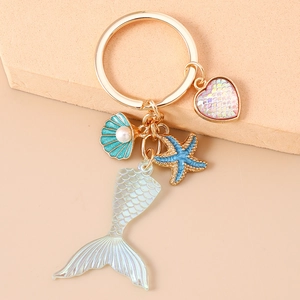 Detailed macro view of mermaid tail keychain with starfish, shell and heart charms