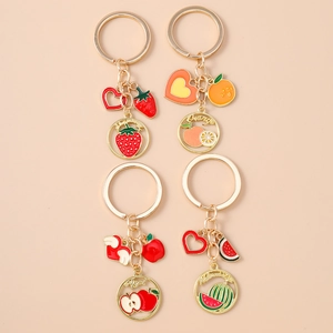 Set of four gold alloy fruit keychains with strawberry orange apple and watermelon charms