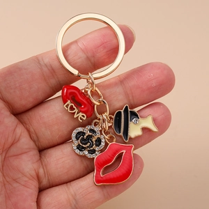 Chic gold keychain with red lips, LOVE pendant, camellia flower, and female silhouette