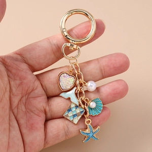 Ocean themed keychain with golden fish tail, pearl shell and starfish pendants