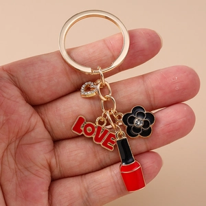 Creative gold keychain with enamel flower, red LOVE charm, and lipstick pendant for bags