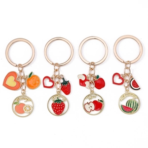 Set of four fruit keychains with orange strawberry apple and watermelon charms