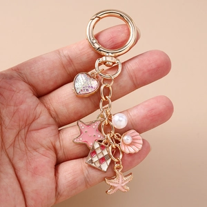 Fashionable ocean theme keychain with pink starfish, heart and pearl shell charms