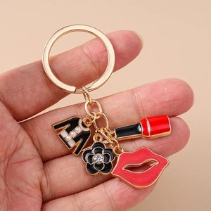 Chic keychain set with gold ring featuring black coat, red lips and flower pendants