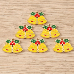 Detailed view of 6 Christmas bell charms with green leaves and red berries for DIY jewelry