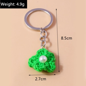 Detail showing dimensions of the handmade crochet flower keychain with pearl center