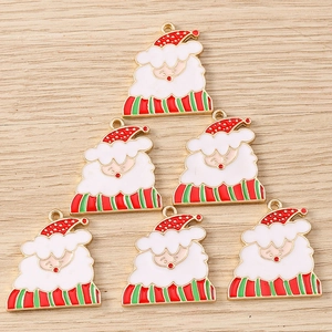 Detailed view of alloy Santa Claus charms with red and green enamel for DIY jewelry