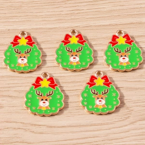 Detailaufnahme von 5 Emaille-Weihnachtsanhängern mit Rentier auf Holzhintergrund
