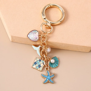 Detailed view of marine themed keychain with fishtail, seashell and starfish charms