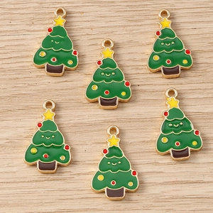 Detailed macro view of six green enamel Christmas tree charms with gold alloy base