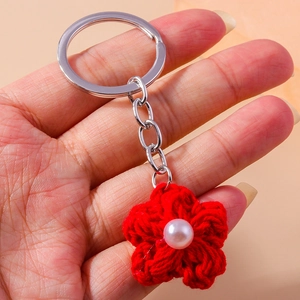 Handmade red crochet flower keychain with white pearl accent and silver metal ring