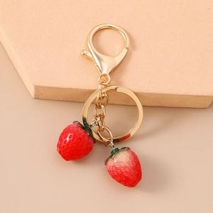 Chic red strawberry keychain with two realistic resin pendants and gold metal hardware