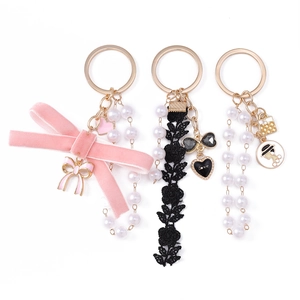 Fashionable pearl tassel keychain set with velvet rose bow and metallic heart pendants