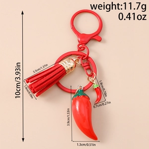 Detailed view of chili pepper keychain with red tassel and measurement markings