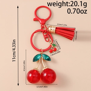Detail view of red cherry keychain with dimensions and weight info on beige background