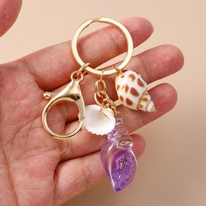 Luminous shell and conch keychain with golden lobster clasp and natural seaside pendants