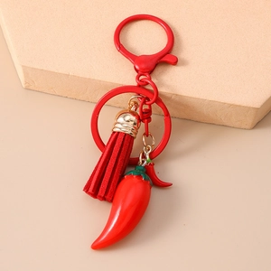 Detailed macro view of creative red chili charms and leather tassel on fruit keychain
