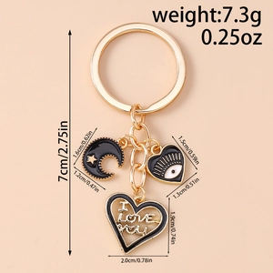 Detail view of gold keychain with eye heart charms and I Love You engraving