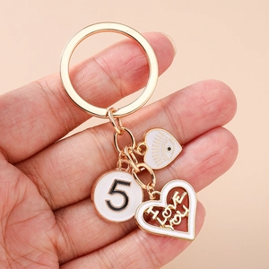 Golden eye and heart keychain featuring number five and I Love You pendant charms