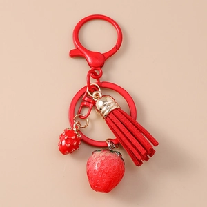 Detail of red strawberry keychain featuring metal lobster clasp, tassel and fruit charms