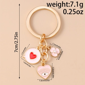 Detailed view of gold keychain with pink heart pendants and precise dimension markings