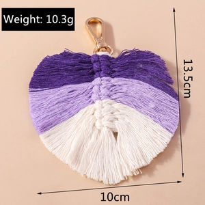 Detailed view of handmade woven leaf keychain with weight and size dimensions