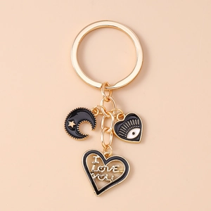 Detail of gold keychain with black enamel heart, moon, and I Love You engraved pendant