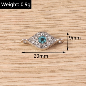Macro view of evil eye jewelry link with blue rhinestones and dimensions 20mm x 9mm