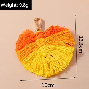 Detail view of orange leaf tassel pendant with dimensions 13.5cm by 10cm and 9.8g weight