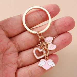 Chic pink enamel heart and bow keychain with gold metal plating for women fashion