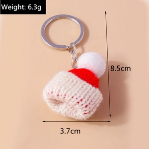 Macro shot of a knitted Christmas hat keychain with size 8.5cm by 3.7cm and weight 6.3g