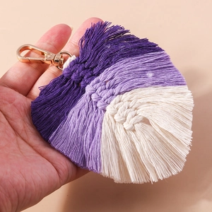 Detail of handmade bohemian woven fan keychain with purple gradient tassels and gold clasp
