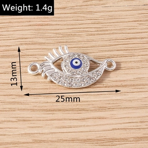 Close-up of silver evil eye connector with blue enamel and rhinestones for DIY jewelry