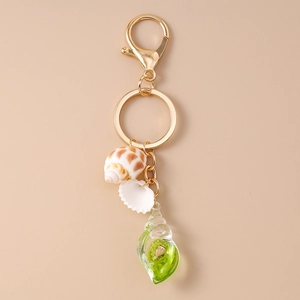 Detail of creative ocean seashell keychain with gold lobster clasp and glass pendant
