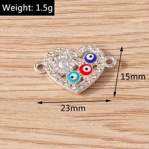 Detail of silver heart evil eye connector with rhinestones for DIY jewelry making