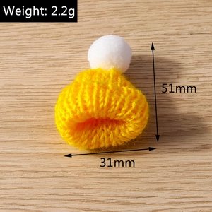 Macro detail of yellow knitted Christmas hat pendant showing 51mm height and size dimensions
