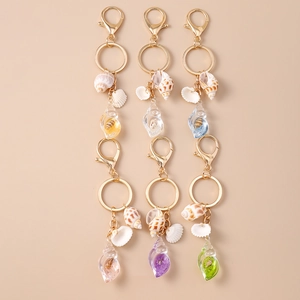 Luminous shell and conch keychains with gold lobster clasps in various summer beach colors