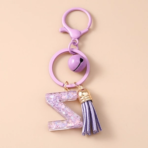Détails du porte-clés lettre Z violet avec pompon, clochette et paillettes étoiles