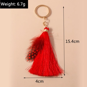 Detailed view of red feather tassel keychain showing dimensions 15.4cm length and 6.7g weight