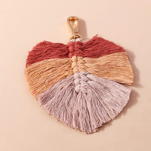 Detail of handmade macrame leaf keychain with colorful cotton fringe and gold clasp