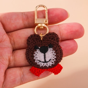 Handmade crochet bear head keychain with red bow tie and golden metal spring clasp