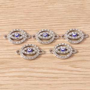 Detailed view of five evil eye connectors with rhinestones for DIY jewelry making