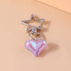 Detail of a purple resin heart keychain with a silver star-shaped metal clasp