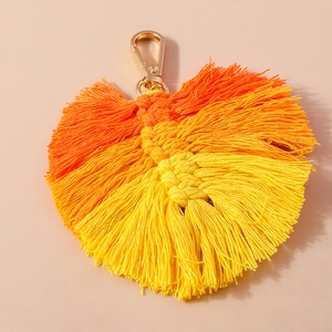 Handmade woven fan keychain with vibrant orange and yellow gradient fringe and gold clasp