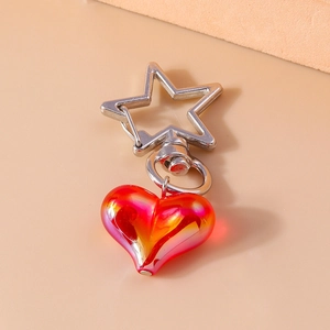 Detail shot of heart-shaped gradient keychain with a silver star-shaped spring clasp