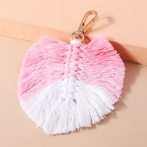 Detailed view of handmade pink and white woven leaf pendant with gold lobster clasp