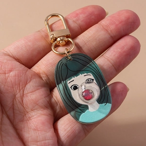 Cartoon girl blowing bubbles acrylic keychain with gold D-ring and heart detail