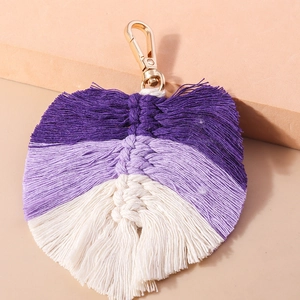 Detail of handmade bohemian woven leaf keychain with purple cotton cords and gold lobster clasp