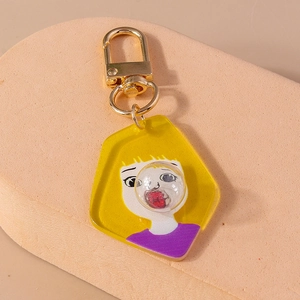 Detail of creative cartoon girl keychain with unique 3D bubble design and gold metal clasp