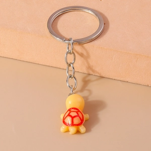 Cute turtle keychain with yellow resin shell and red patterns on silver metal ring